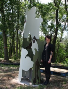 Artist Mallory McClellan with her newly-installed sculpture, Sycamore.